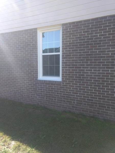 single window on side of brick house