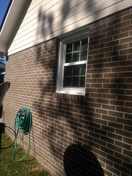 small single window on side of brick house