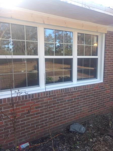 triple window on brick house
