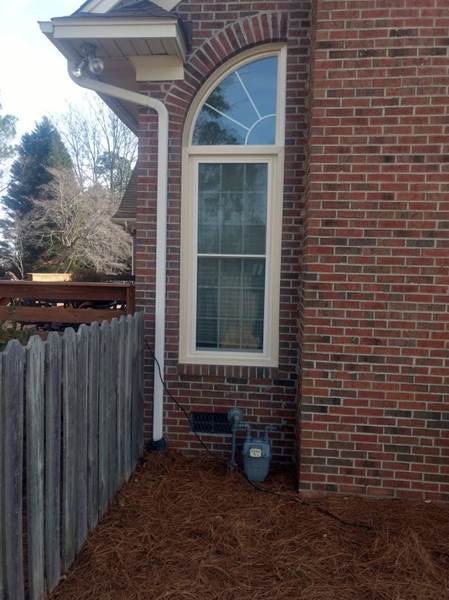 single window with decorative curved corner window on top