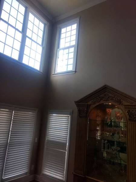 inside corner view of large double window and single window on second floor
