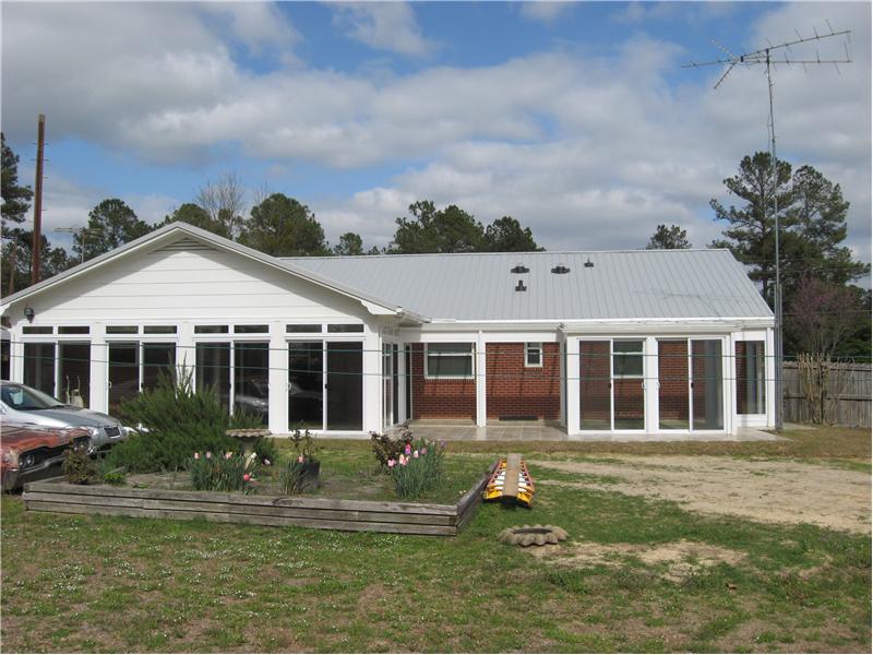 back of house with sunroom addition