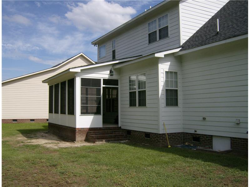 white sunroom added to back of white house