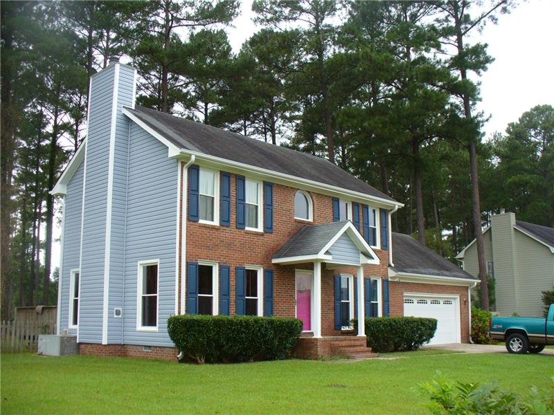 Brick house with blue vinyl siding