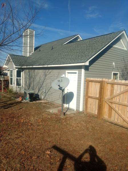 Vinyl Siding on Side of Home Near Fence, Fayetteville NC Siding Contractor