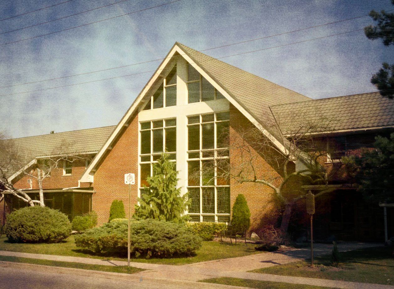 The Thornhill brick building with a white cross on the front of it