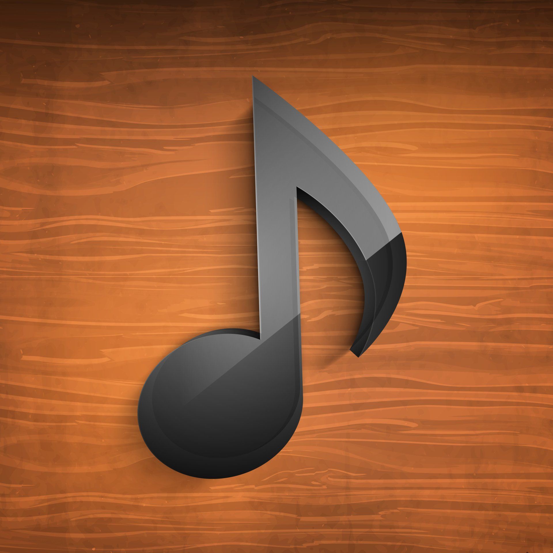 a black music note on a wooden surface