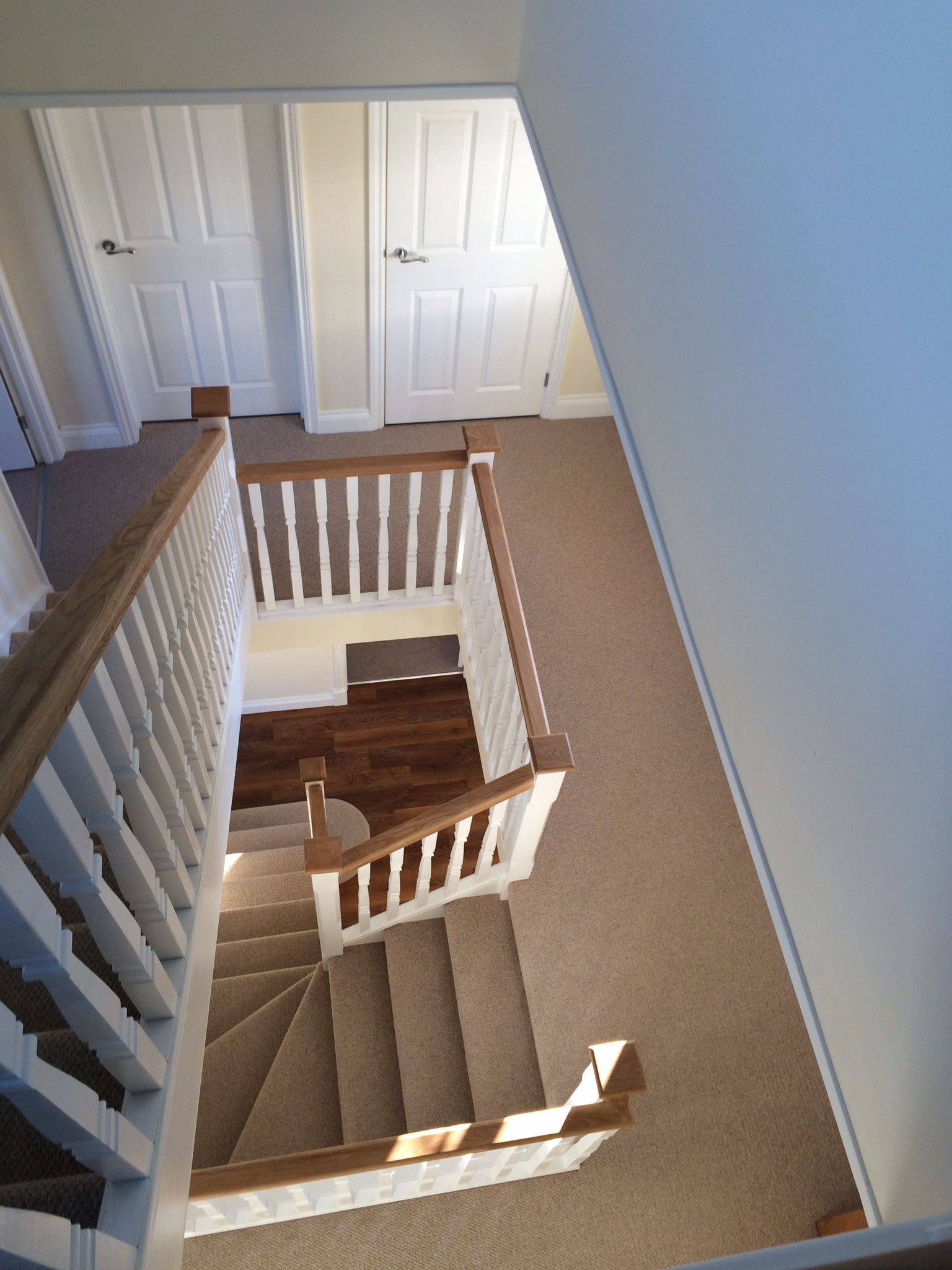 brown carpeted staircase and flooring