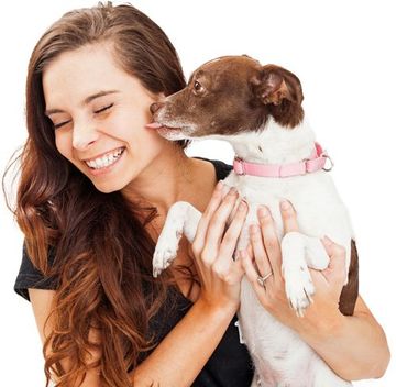young women holding a dog