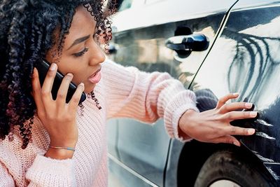 Black Woman Feeling Sad After Scratching Her Auto — Trinidad, CO — Griego Insurance Agency Black Woman Feeling Sad After Scratching Her Auto — Trinidad, CO — Griego Insurance Agency