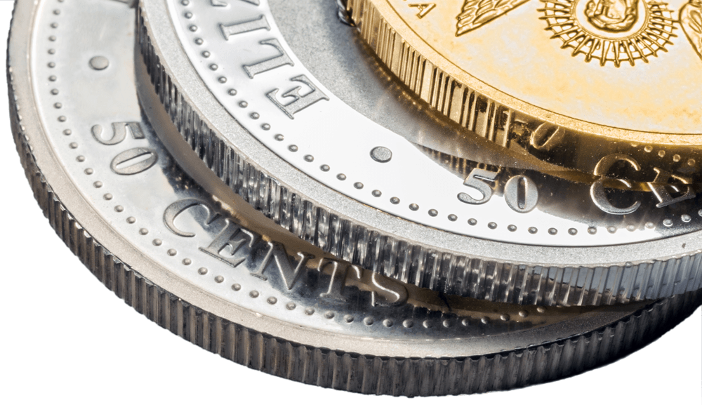 Three different coins are stacked on top of each other