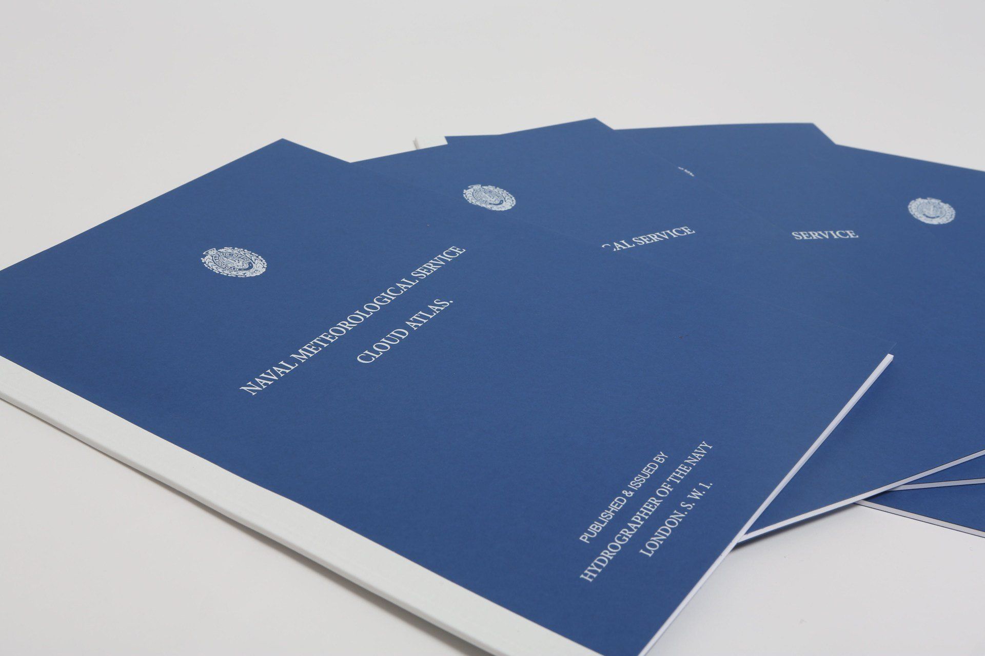 A stack of blue folders with a white border