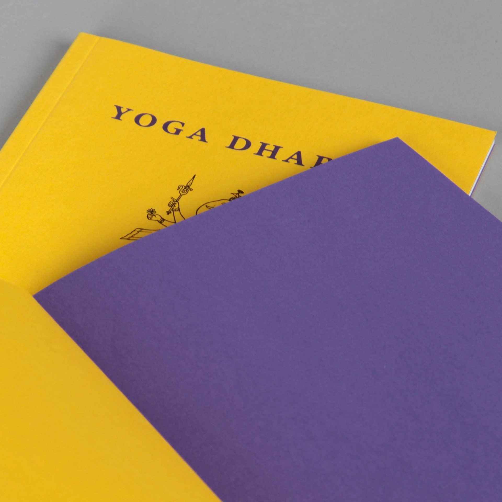 A yellow and purple book titled yoga dharma