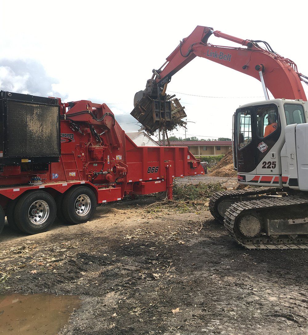 Excavator Collecting Waste — Fort Wayne, IN — Worx Companies