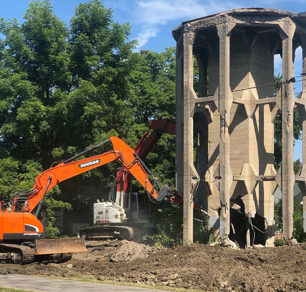Excavator Using Hydraulic Stone Breaker — Fort Wayne, IN — Worx Companies