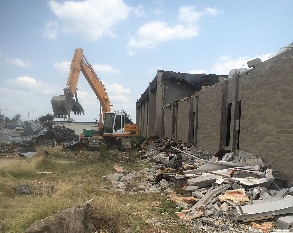 Demolishing Building Using Excavator — Fort Wayne, IN — Worx Companies Demolishing Building Using Excavator — Fort Wayne, IN — Worx Companies