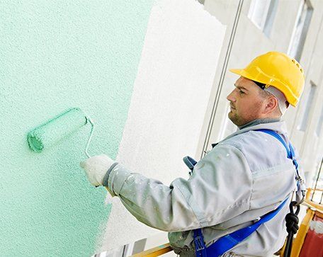 Exterior Painting — Painter Working on the Building Exterior in Central Florida Exterior Painting — Painter Working on the Building Exterior in Central Florida