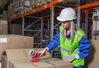 Packing — Worker Packing Boxes in Cullman, Alabama Packing — Worker Packing Boxes in Cullman, Alabama