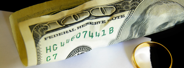 100 dollar bill and wedding ring