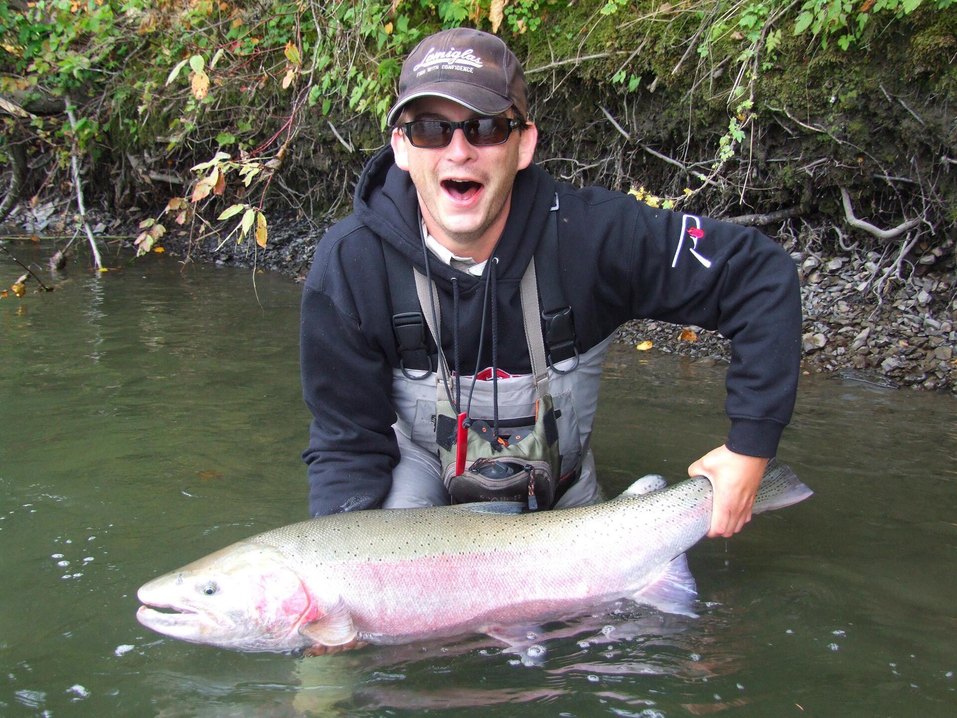 Man Holding Fish - Auburn, WA - Auburn Sports & Marine Man Holding Fish - Auburn, WA - Auburn Sports & Marine