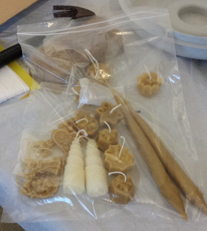 a bag of Christmas decorations and candles made by the workshop attendees to take home