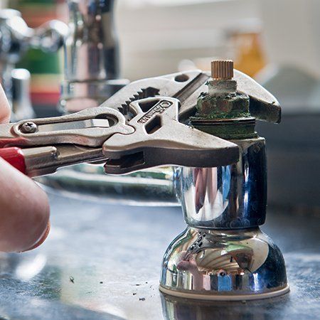 Clute Plumbers — Person Fixing Faucet in Clute, TX Clute Plumbers — Person Fixing Faucet in Clute, TX