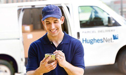 Hughesnet technician in front oif truck