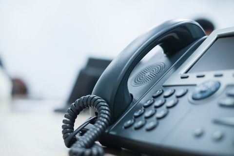 Phone Installations — Technician Installing a Smartphone in Miami Valley, OH Phone Installations — Technician Installing a Smartphone in Miami Valley, OH
