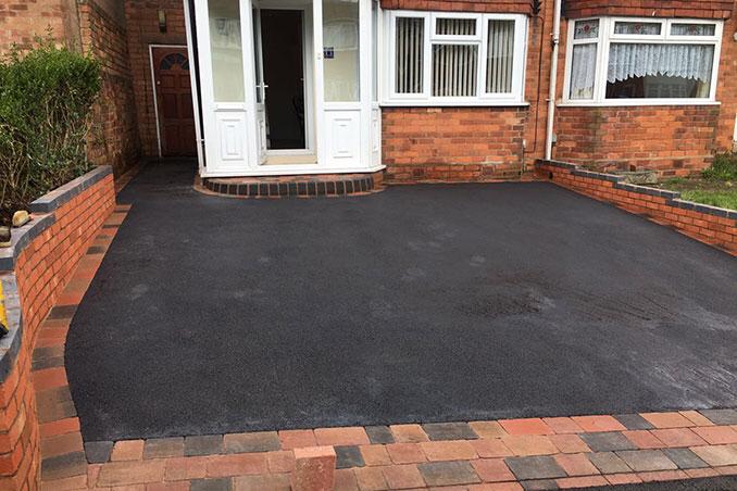 A tarmac driveway fronting a house