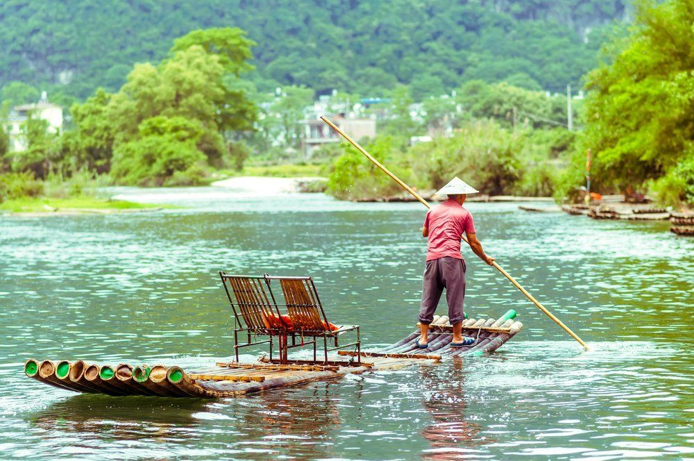 Local with Bamboo on Li river in Yangshuo China