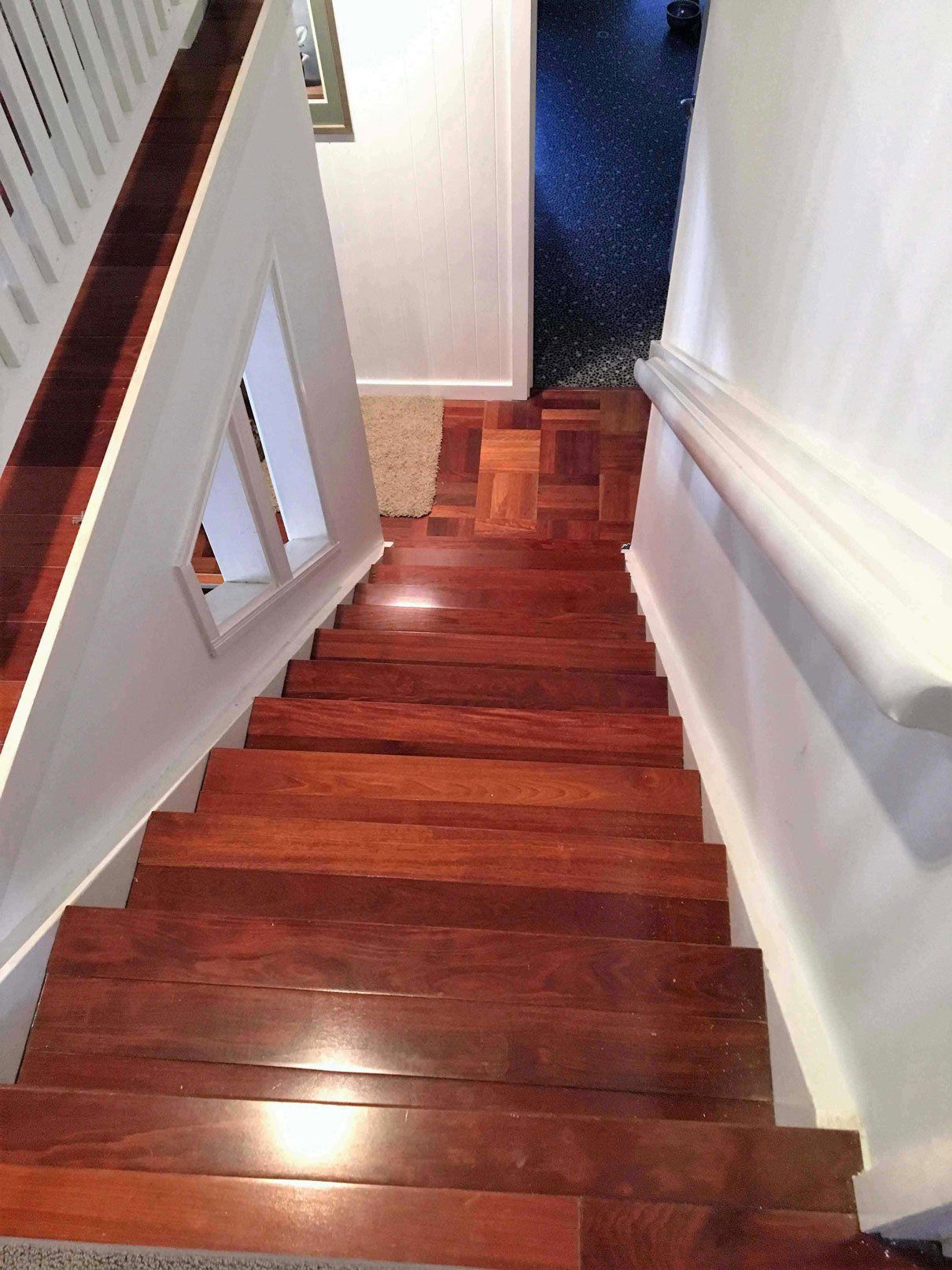 brown floor wooden stairs with white wall