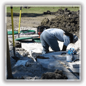 Septic Services in Alvin — A Man Repairing a Septic Tube in Alvin, TX Septic Services in Alvin — A Man Repairing a Septic Tube in Alvin, TX