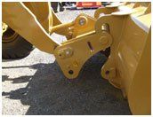 A yellow bulldozer is parked on the side of the road.