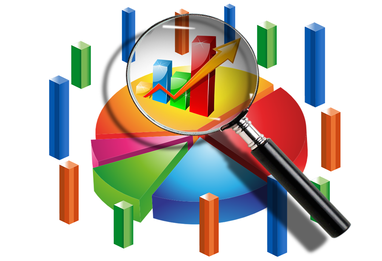A magnifying glass is looking at a pie chart
