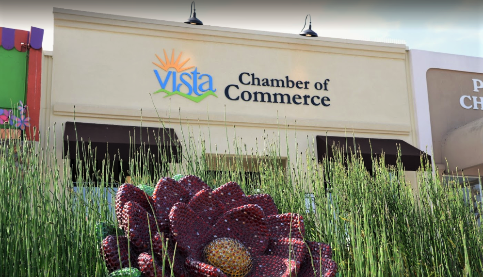 A vista chamber of commerce building with a flower in front of it