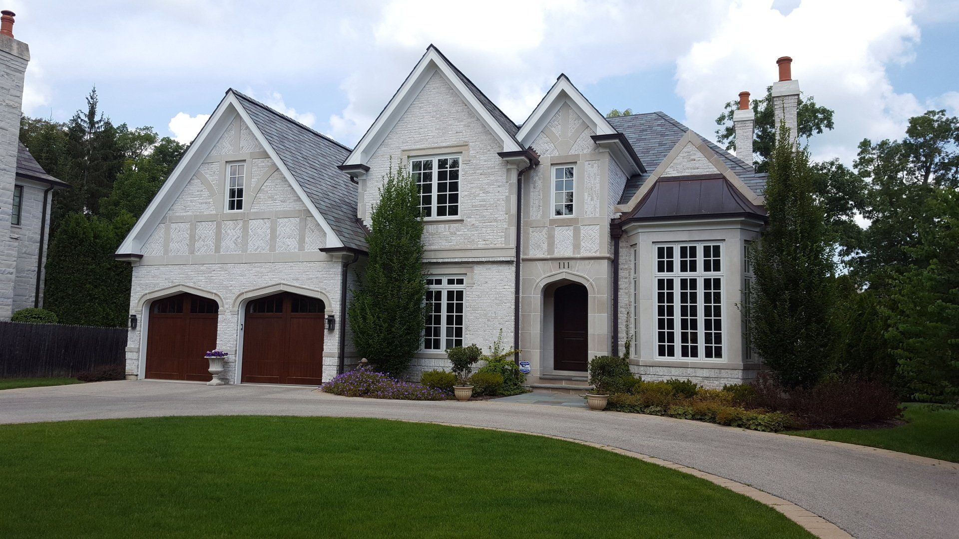 A large white house with a driveway leading to it