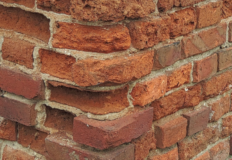 A close up of a brick wall with a lot of bricks