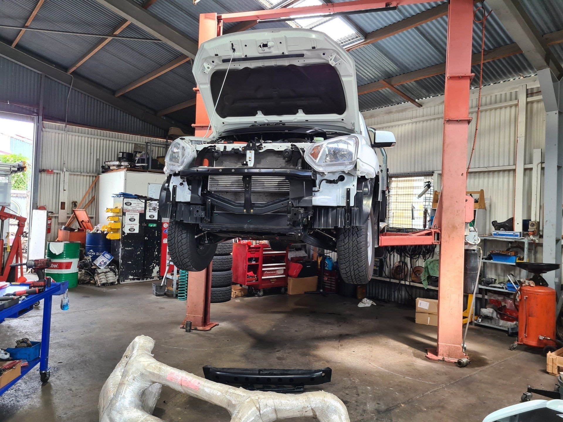 Ute Hoisted Up in Mechanic's Workshop - Specialist Mechanics in Cairns, QLD