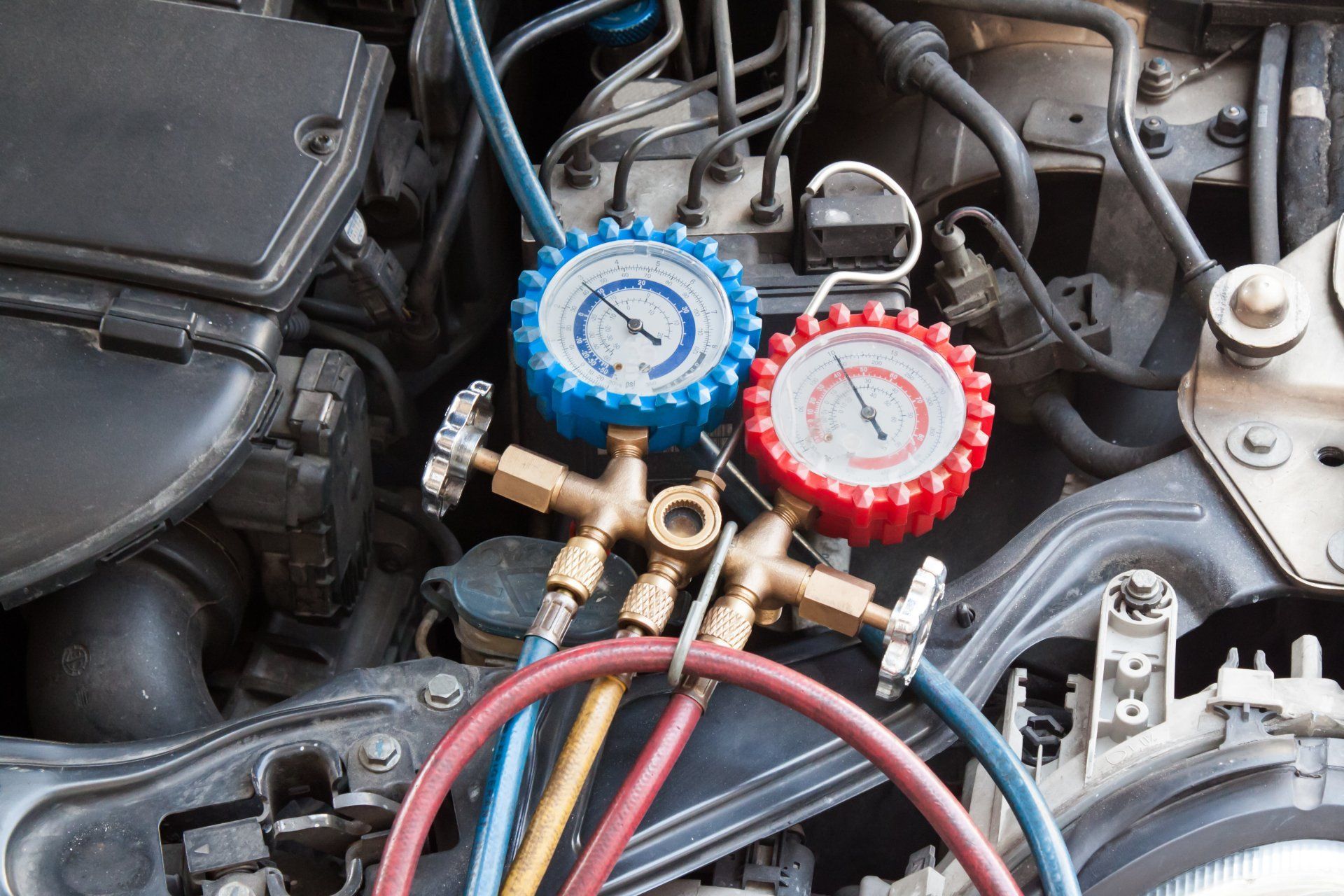 Manometer Being Used To Gauge Air Conditioning Pressure - Specialist Mechanics in Cairns, QLD