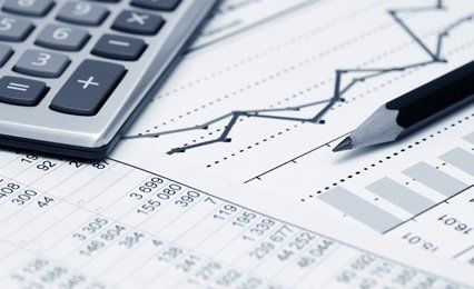 A pencil and calculator on sheets of figures