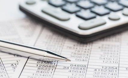 Sheets of figures, calculator and pen