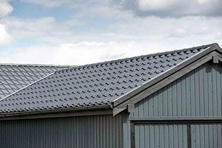 Gray roof with gutter — Metal roofs in Riceville, TN Gray roof with gutter — Metal roofs in Riceville, TN
