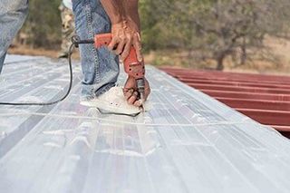Working On Metal Roof — Metal roofs in Riceville, TN Working On Metal Roof — Metal roofs in Riceville, TN