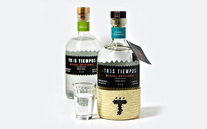 Two bottles of tequila are sitting next to each other on a table.