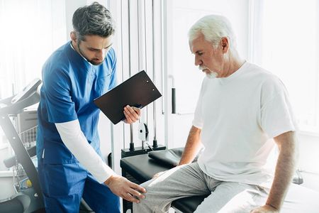 Nurse Checking Patient Knees — DFW, TX — Texas Non-Surgical Orthopedic Nurse Checking Patient Knees — DFW, TX — Texas Non-Surgical Orthopedic
