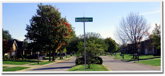 A street in a residential area with a sign that says kensington