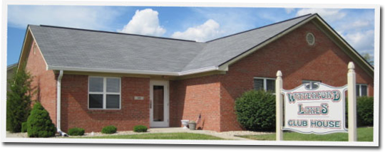 A brick house with a sign in front of it that says 