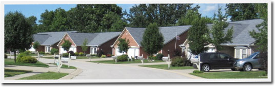 A row of houses with cars parked in front of them