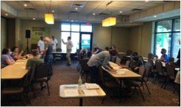 A group of people are sitting at tables in a room.