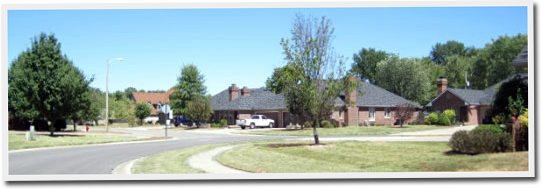 A residential neighborhood with houses and trees on a sunny day
